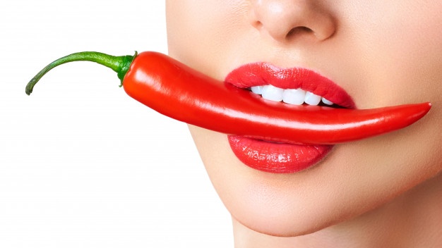 beautiful woman teeth eating red hot chili pepper 168410 576